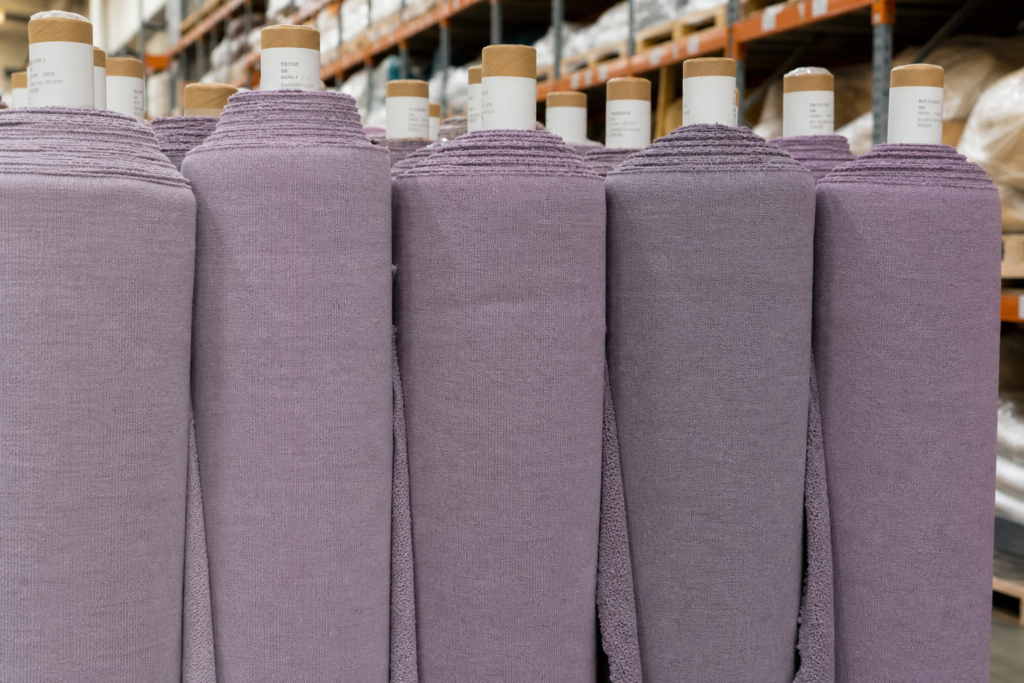Fabric rolls in the same color but slightly different shades standing side by side to illustrate dye lot variation