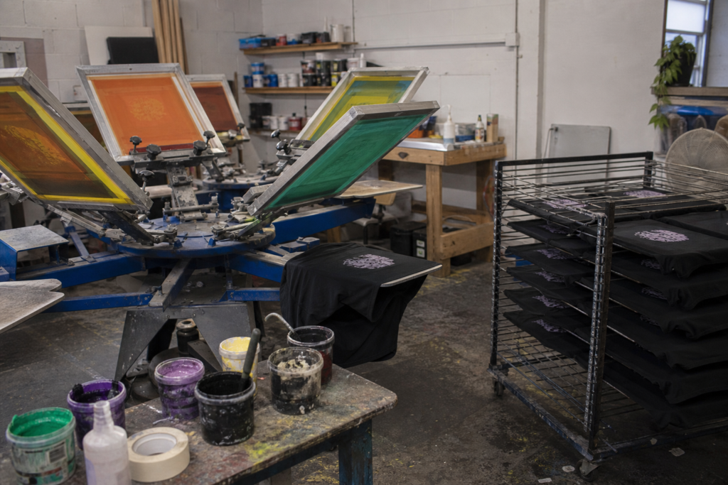 Screen printing setup for a small T-shirt order showing how printing preparation costs impact low-MOQ production